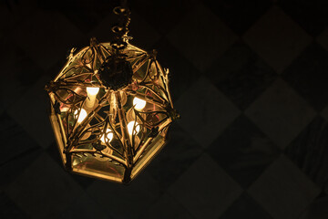 Wall Mural - Ancient chandelier with electric candle lights inside. Close up