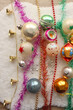 Colorful vintage Christmas ornaments and white faux fur blanket. Cute and kitschy Christmas decorations. Top view.