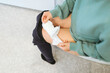 © Johnér - Woman using sanitary pad in bathroom
