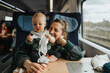 © Johnér - Woman traveling with baby by train