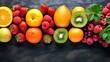 Fresh fruits and berries on black background. Top view