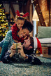canvas print picture - Playful family has fun on Christmas Eve at home.