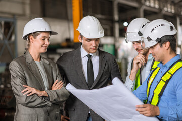 Wall Mural - group of industry people engineer brainstorm team builder architect and technician talking consulting together in site building for renovation planning with floor plan together.