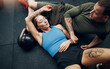 © Flamingo Images - Fit young friends lying on a gym floor after a workout session
