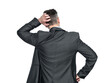 Rear view, a man in a dark suit thinks and scratches his head with his hand, isolated on a transparent background png