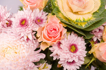 Bouquet of beautiful flowers with pink roses, brassica flower, chrysanthemum and freesia flower.