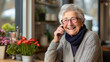 Happy senior woman holding photo and cell phone