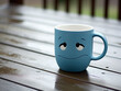 Sad-faced blue mug on a rainy table. Blue Monday.