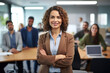 Smiling confident business leader looking at camera and standing in an office at team meeting. Portrait of confident businesswoman with colleagues in boardroom. Using digital tablet during a meeting