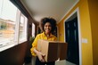 © Georgii - Courier woman smiling delivering parcel with tablet for painting, parcel delivery.