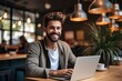 © visoot - A man sitting on chair is working with laptop in a co-working space, Smiling face, Happiness.