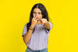 I am watching you. Confident attentive woman pointing at her eyes and camera, show I am watching you gesture spying on someone. Pretty disappointed Indian girl isolated on yellow studio background
