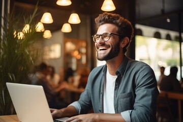 Aufkleber - A business owner looking at a laptop and smiling, Happiness.