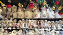 Many Fairy Tale Toy Characters And Dolls Soft White Figures In Hats For Sale In The Store Before Christmas. A Large Selection Of Cute Handmade Christmas Gifts Of Elves, Trolls, Snowmen, Dolls 