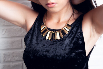 Poster - young woman wearing black necklace posing