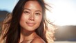 Celebrate radiant skin! An Asian woman with a sunburned face embraces the summer sun outdoors. Convey the importance of sun protection and skincare with this vibrant stock image.