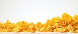 Fototapeta  - isolated background, a heap of white, yellow and crisp corn flakes sit in a pile, their crimp edges making them appear even more crispy and inviting as a delightful breakfast food object.