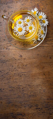 Sticker - chamomile tea on an old wooden table