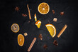 Making mulled wine, the main drink at Christmas markets. Falling ingredients on a dark background. Christmas banner.