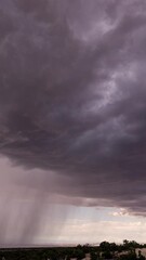 Wall Mural - Vertical Timelapse of monsoon storm moving through the Utah desert as clouds rotate in the sky.