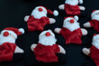 © Irik - Funny Santa Claus toys lying on black table background