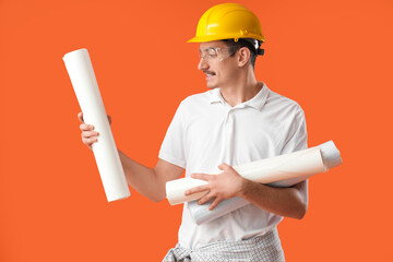 Wall Mural - male worker with wallpapers on orange background