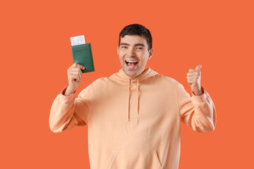 Sticker - Happy young man with passport on orange background