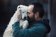 © Budimir Jevtic - Man holding and hugging dog in shelter