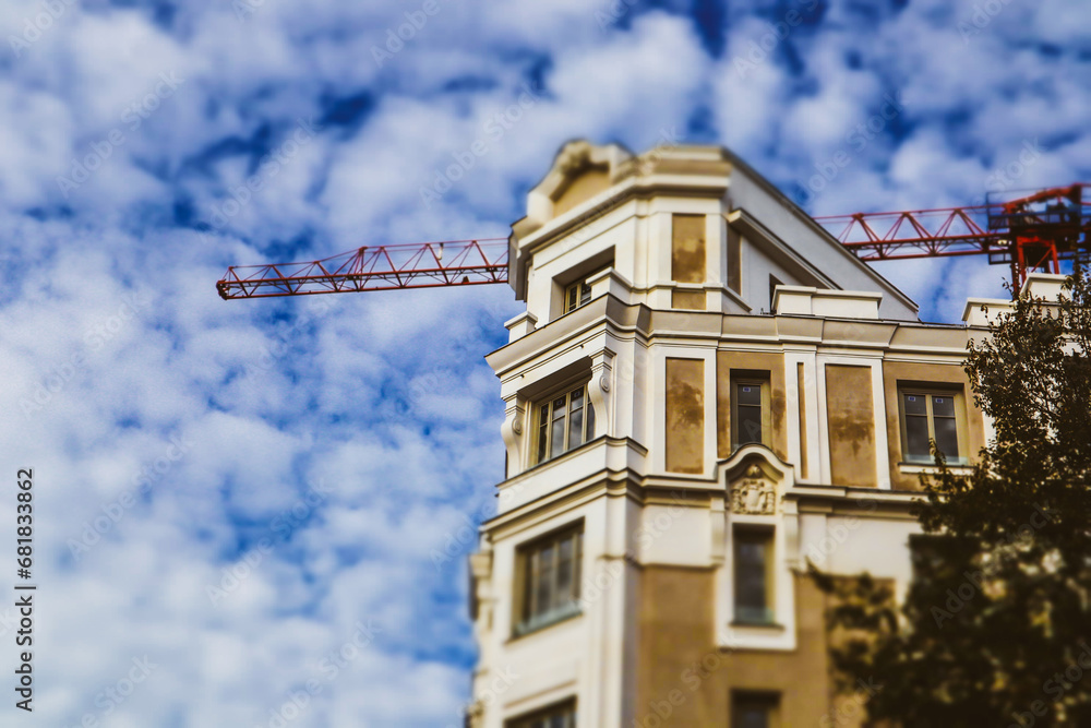 Picture of An old beige house, apartment building under construction on a city ...