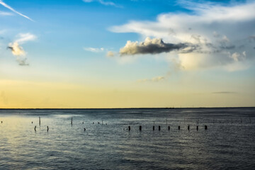 Wall Mural - yellow sunrise clouds over lake