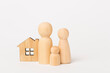 © Liami - Wooden family figures with house on color background