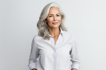 Wall Mural - Portrait of happy mature businesswoman with grey hair smiling at camera.