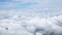 Blue Sky With White Fluffy Clouds From Airplane Flight Fly Over The Clouds In A Sunny Day With Cloud Moving In The Atmosphere In Hot Weather Summer Time.