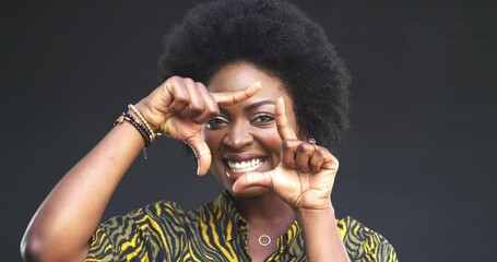 Wall Mural - Face, happy and a woman with a hand frame, positive attitude and afro hair on a grey background. Portrait, black person and photography with confidence, smile and closeup for photographer creativity