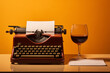 Typewriter with inserted blank sheet of paper and glass of wine