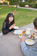 Couple eats Indian food at picnic table