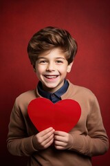 Happy little boy with red hearts on Valentine's Day.