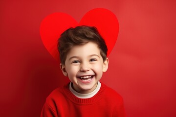 Happy little boy with red hearts on Valentine's Day.