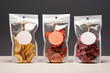Packages of assorted sweet dried fruit chips and slices on light background