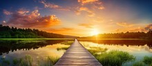 In The Picturesque Landscape Of A Summer Vacation, The Vibrant Green Grass Swayed Gently As The Sun Set, Casting A Golden Light On The Wooden Bridge, Creating A Beautiful Contrast With The Colorful