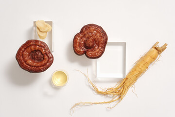 Sticker - Advertising scene with rare medicine - lingzhi mushrooms and ginseng root displayed on white background with glass podiums. Ginseng and Ganoderma are both medicinal herbs that help improve health