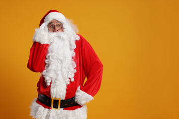 Canvas Print - Merry Christmas. Surprised Santa Claus on orange background, space for text