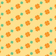 Digital png illustration of orange and green clover leaves repeated on yellow background