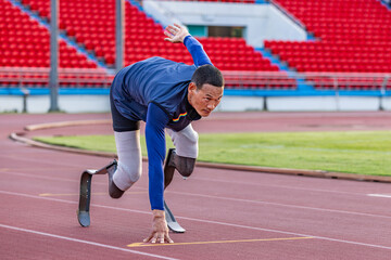 Asian para-athlete with prosthetic blades leg in stadium practicing workout for Paralympic running competition. Amputee sportsman runner practicing running workout. Disabled athlete man sport concept.