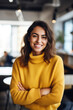 © Jasmina - Portrait of beautiful happy woman in yellow sweater looking at camera in the office, blurred people in background