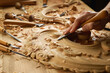 Hands of craftsman carve with a gouge in the hands on the workbench in carpentry. Wood carving tools close-up