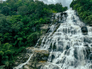 Wall Mural - beautiful waterfall in lush tropical green forest. nature landscape. mae ya waterfall is situated in