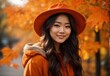 © MochSjamsul - Woman in autumn season, wearing orange costume theme and hat, autumn leaf and tree decoration on the background