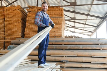 Wall Mural - Joiner in uniform check boards on timber mill