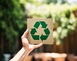 © MdBaki - Hand Holding Recycled Paper Sign in Bokeh Background